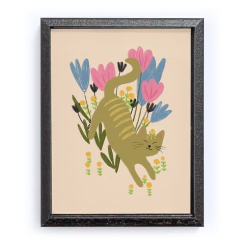 Mockup of a framed artwork with a simplistic drawing of a green happy cat frolicking within flowers on a calm beige background