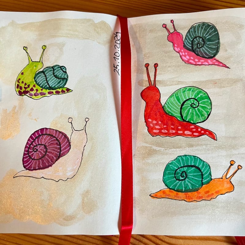 A photo of a sketchbook spread with five colourful simplistic snail illustrations made with markers and fine liners by Mervi Eskelinen